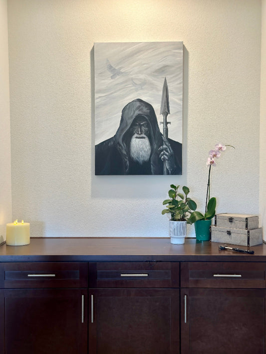 Canvas print of a hooded figure with a spear on a wall above a desk.